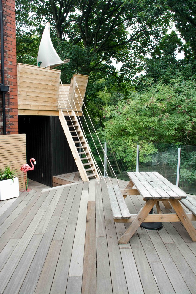 This is an example of a small contemporary backyard outdoor playset in Manchester with decking.
