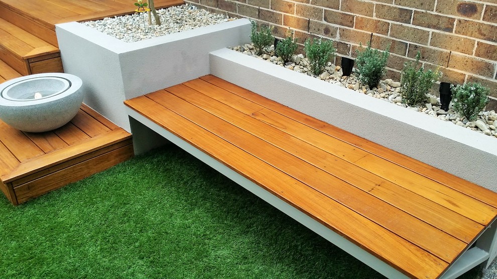 Inspiration for a small contemporary partial sun backyard water fountain landscape in Melbourne with decking.