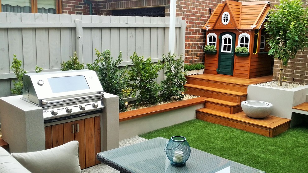 Photo of a small contemporary partial sun backyard water fountain landscape in Melbourne with decking.