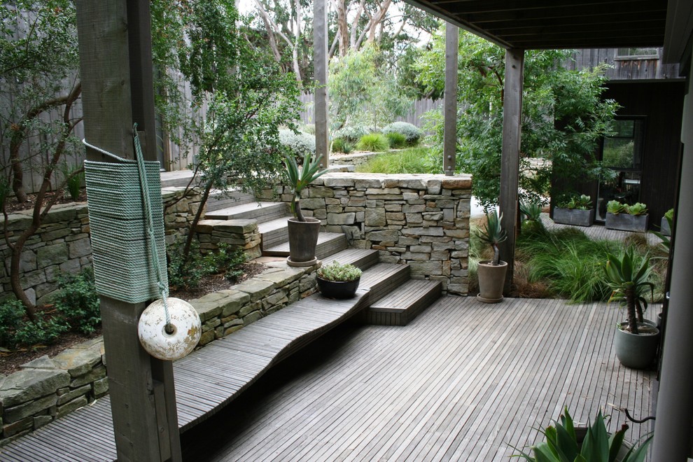 Design ideas for a large coastal front xeriscape fully shaded garden in Geelong with decking.