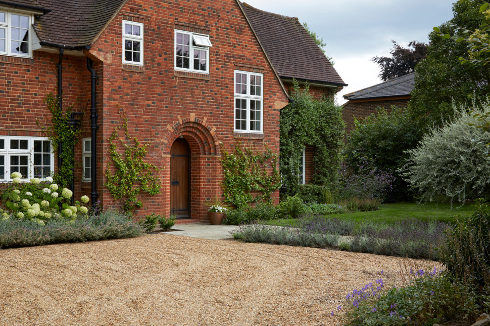 Photo of a large contemporary front yard driveway in London.