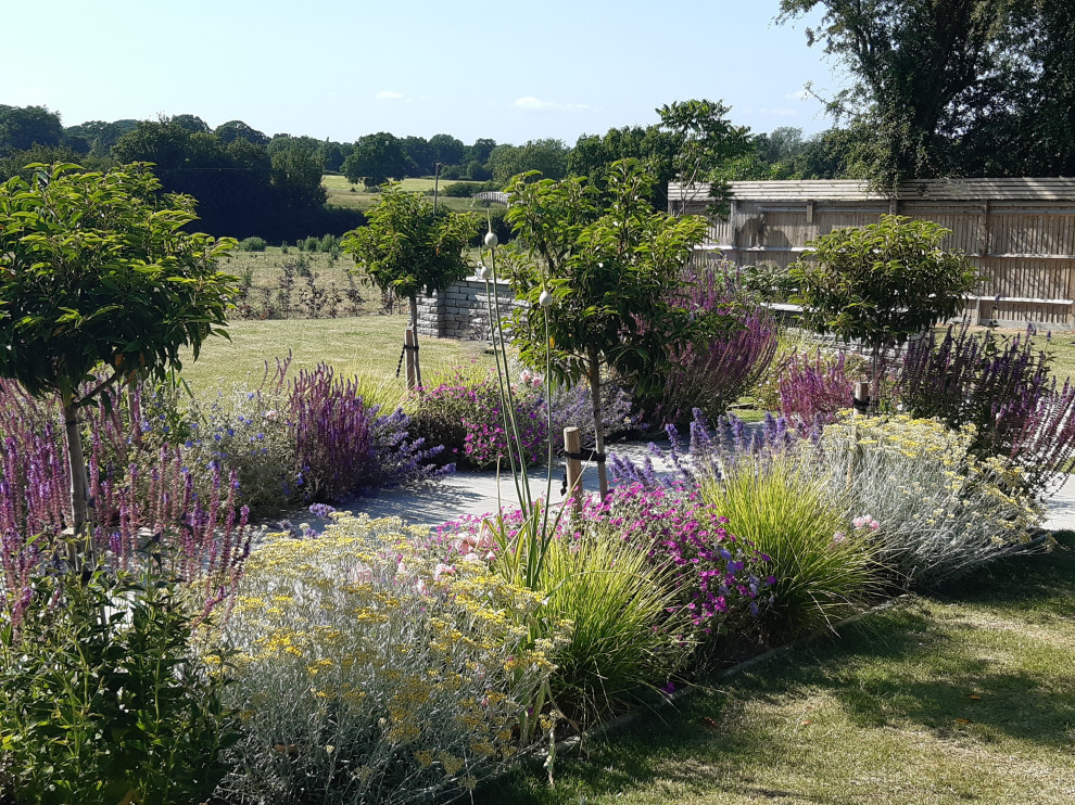 Esempio di un grande giardino formale country esposto in pieno sole dietro casa in estate con un ingresso o sentiero e pavimentazioni in pietra naturale