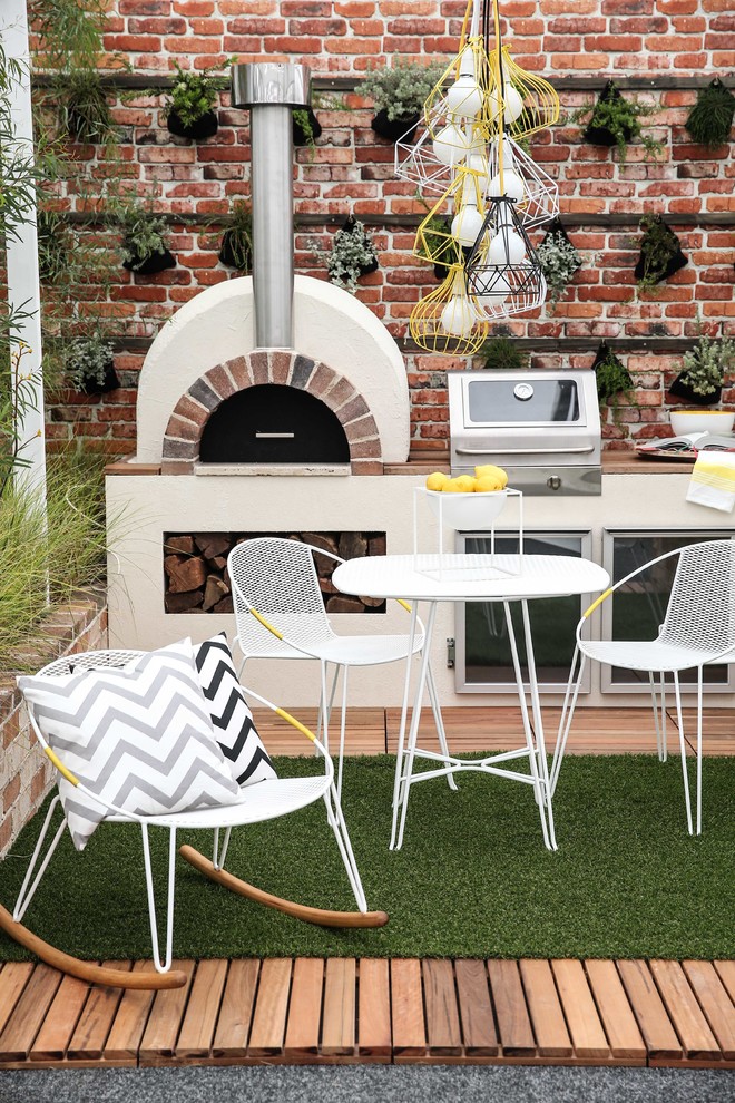 Example of a small trendy courtyard brick patio design in Sydney with a fire pit