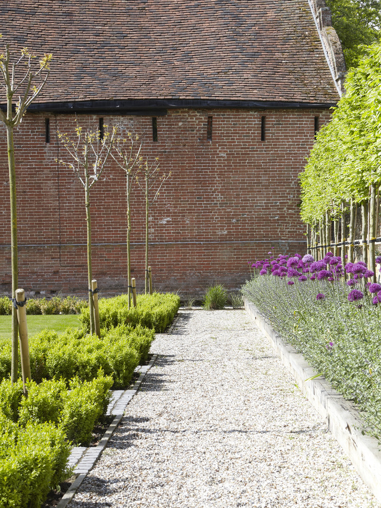 Inspiration for a large farmhouse full sun courtyard stone outdoor sport court in London.