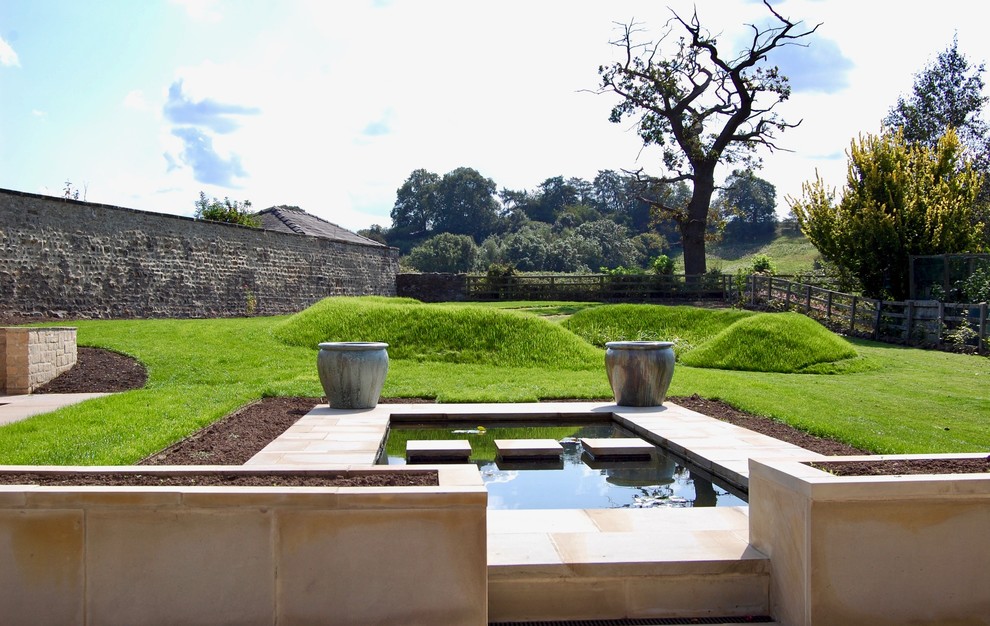 Modelo de jardín de estilo de casa de campo de tamaño medio en patio trasero con jardín francés, exposición total al sol y adoquines de piedra natural