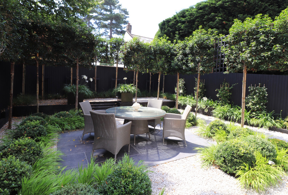 This is an example of a mid-sized contemporary partial sun backyard formal garden in Kent for summer.