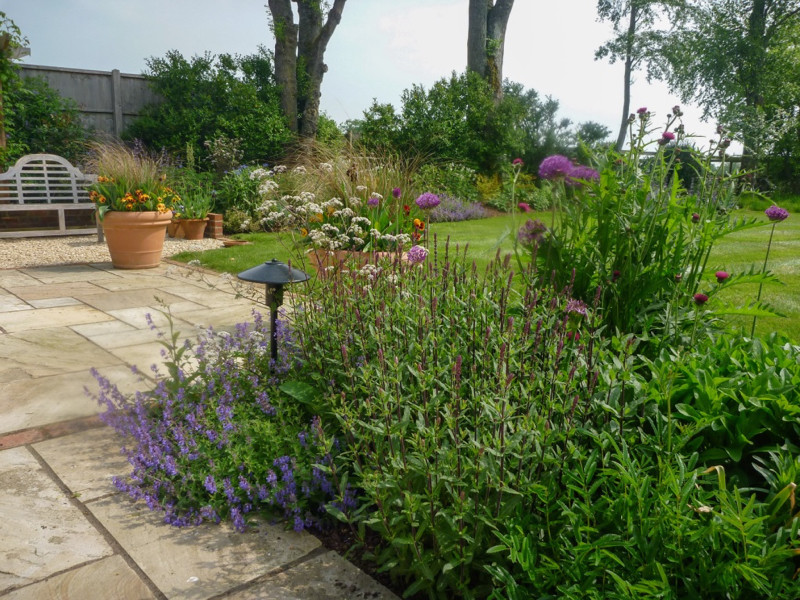 Photo of a medium sized traditional back garden for summer in Hampshire with gravel.