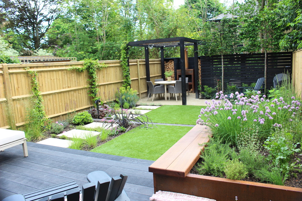 Design ideas for a small contemporary back formal partial sun garden for summer in Hampshire with decking.