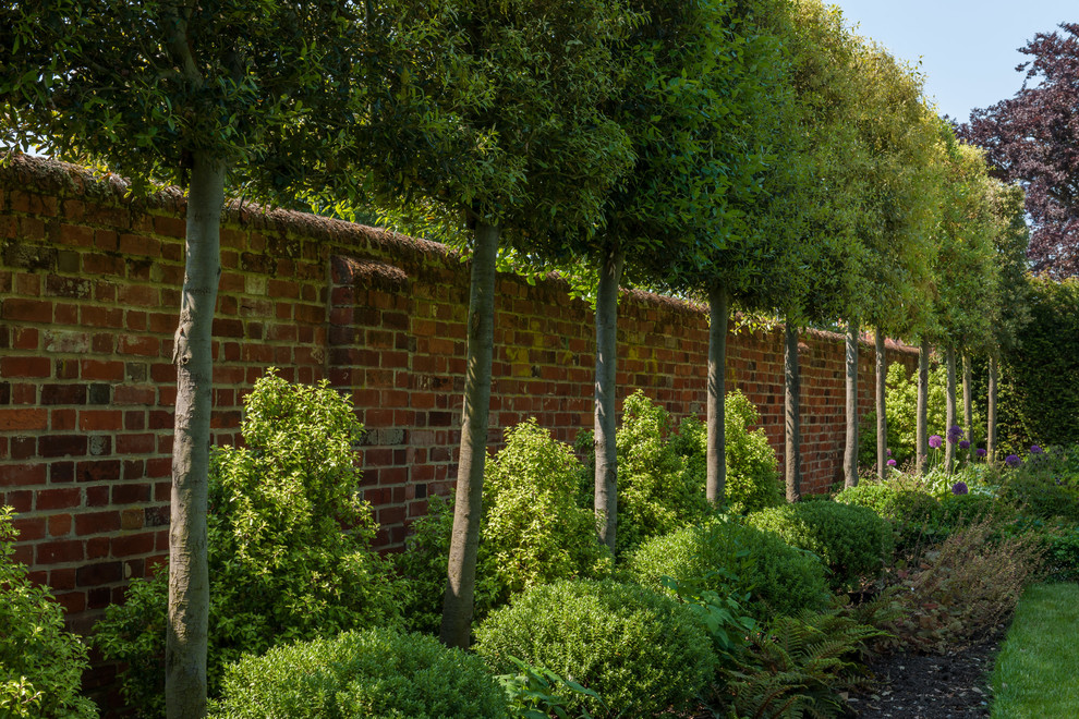 Medium sized traditional back formal garden in Hertfordshire.
