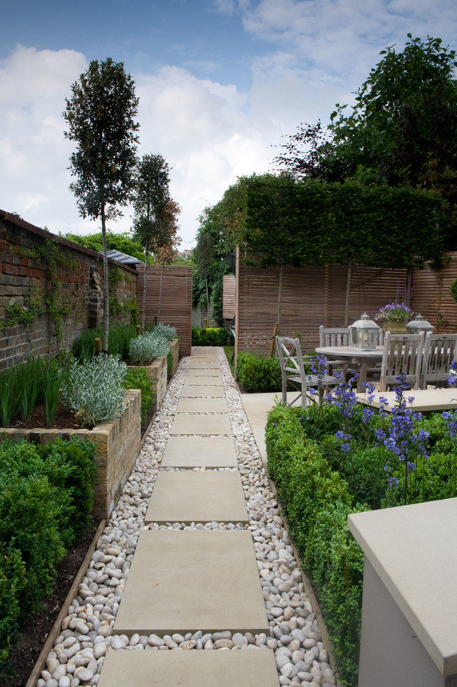 Inspiration for a small classic back formal fully shaded garden in London with natural stone paving and a raised bed.