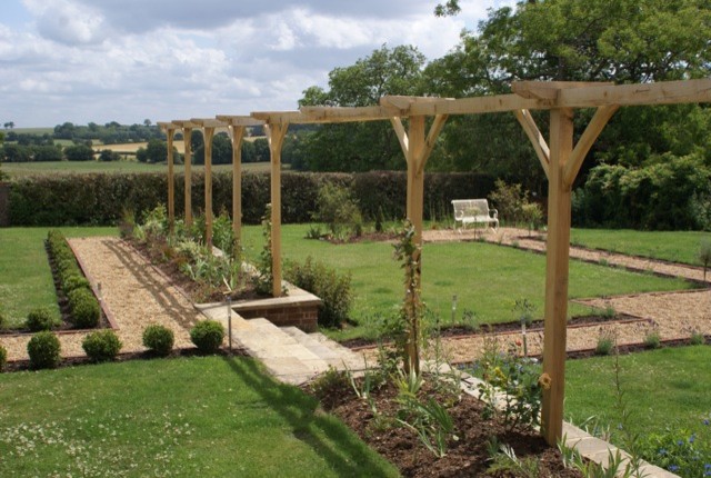 Photo of a large classic formal full sun garden for summer in Cheshire.