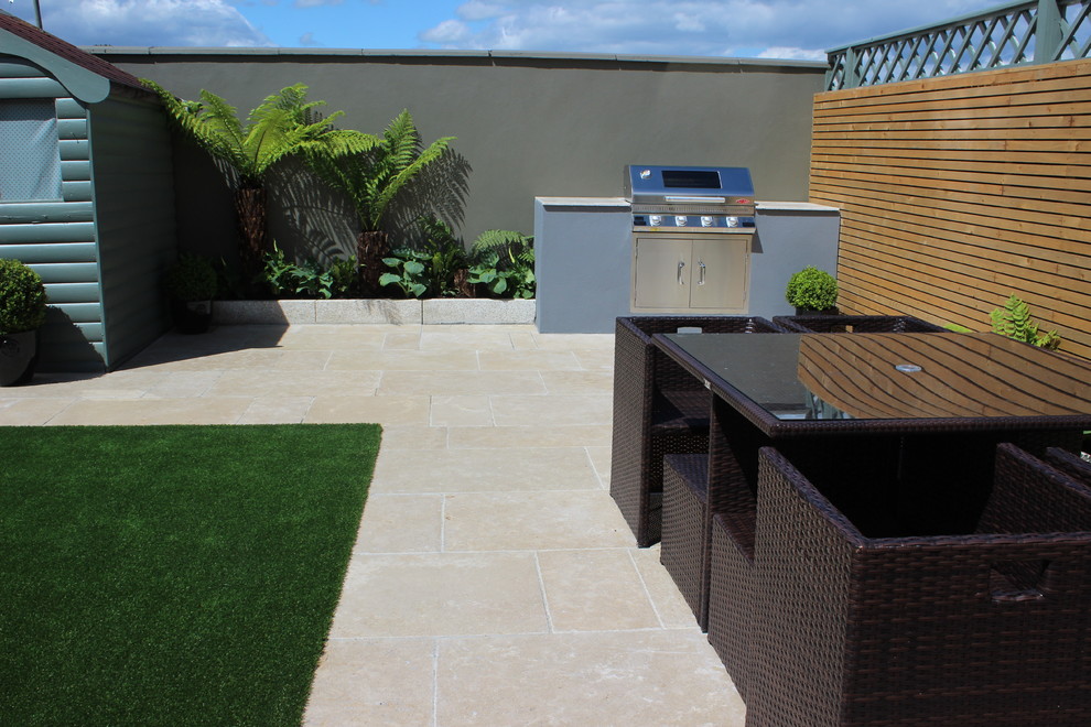 Photo of a small contemporary full sun backyard stone and wood fence formal garden in Dublin for summer.