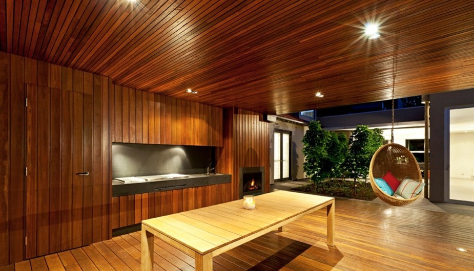 This is an example of a contemporary back partial sun garden in Melbourne with a fire feature and decking.