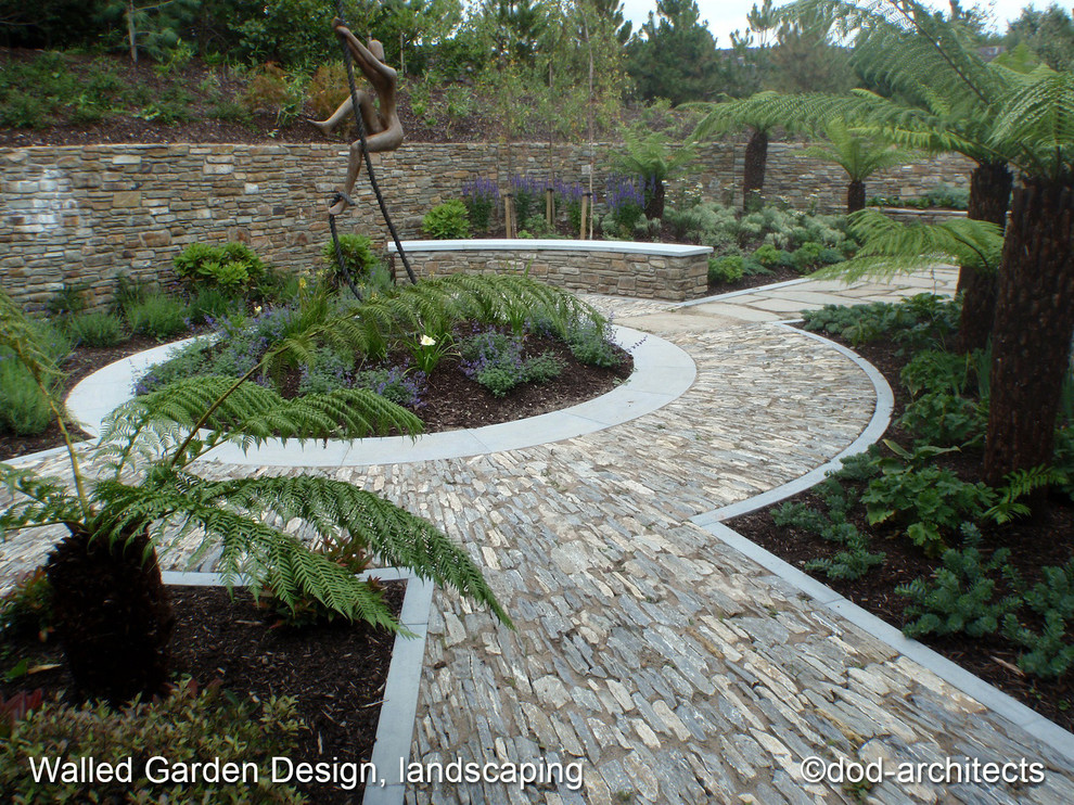 Inspiration for a large contemporary partial sun side yard stone formal garden in Other for summer.