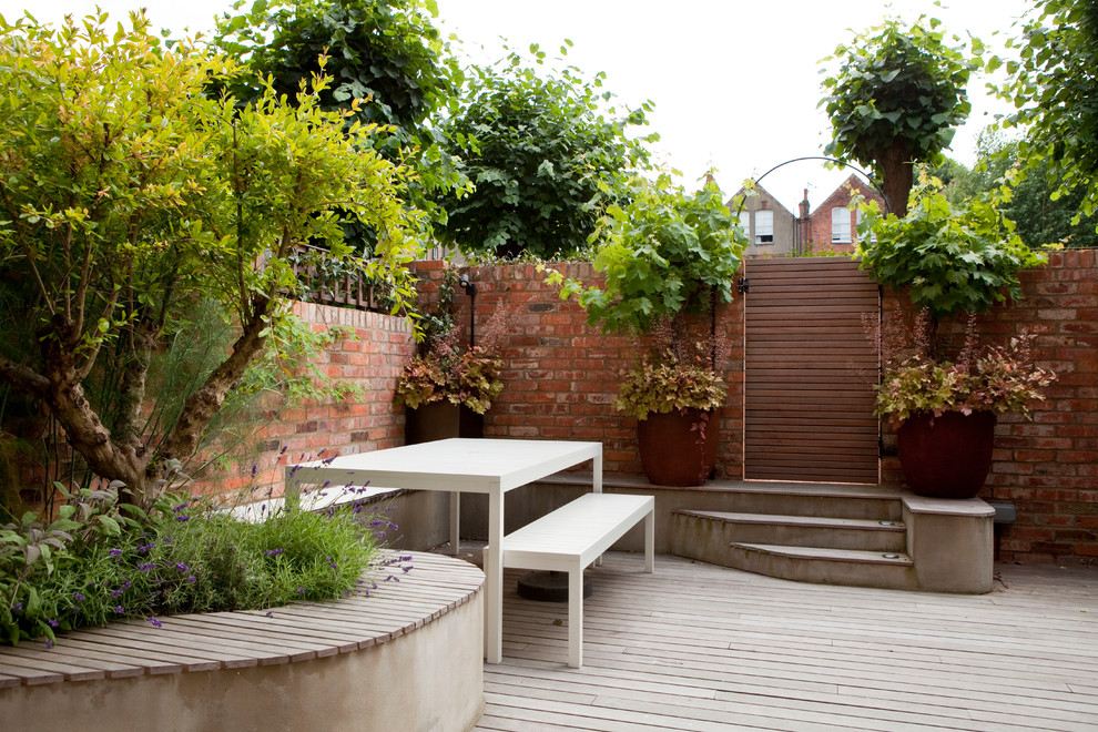 Inspiration for a medium sized contemporary back garden seating in London with a potted garden and decking.