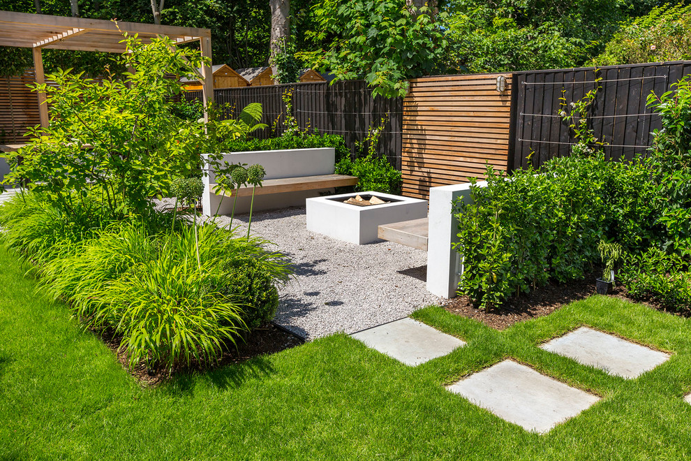 Design ideas for a large contemporary back full sun garden for summer in London with natural stone paving.