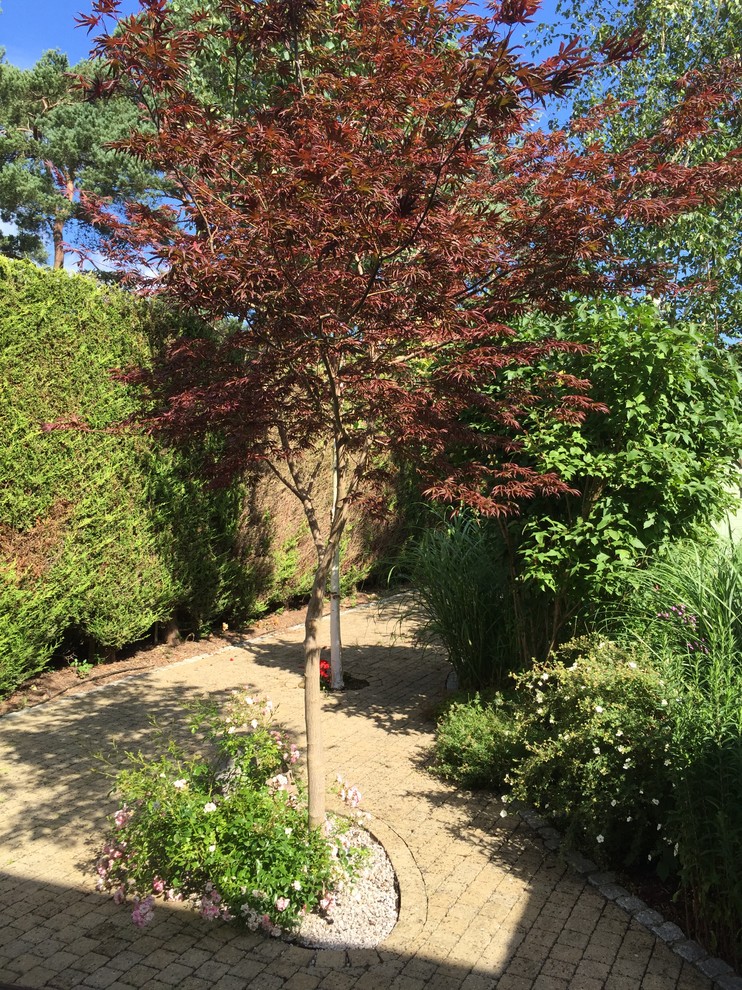 Großer Eklektischer Garten im Sommer, hinter dem Haus mit direkter Sonneneinstrahlung und Natursteinplatten in Surrey