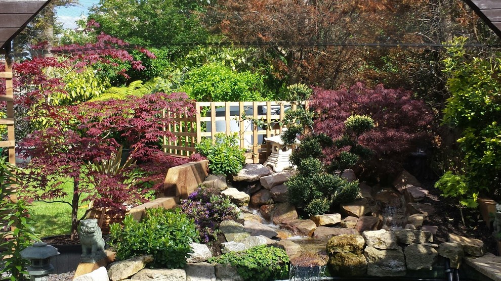 This is an example of a traditional backyard pond in Essex.