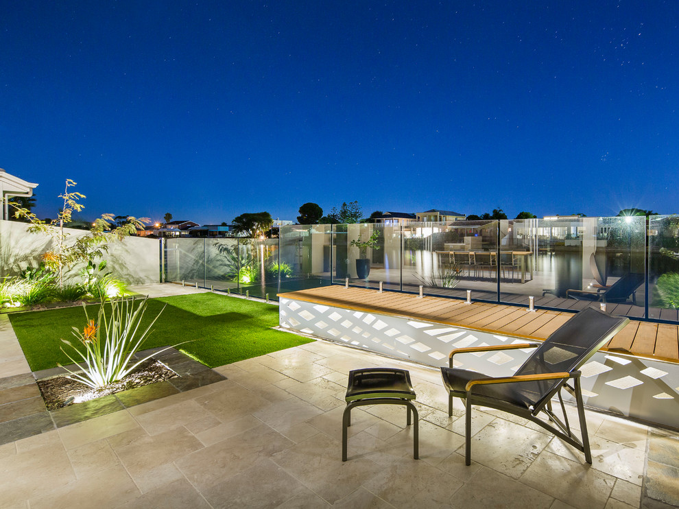 Inspiration for a small contemporary full sun backyard stone formal garden in Adelaide.