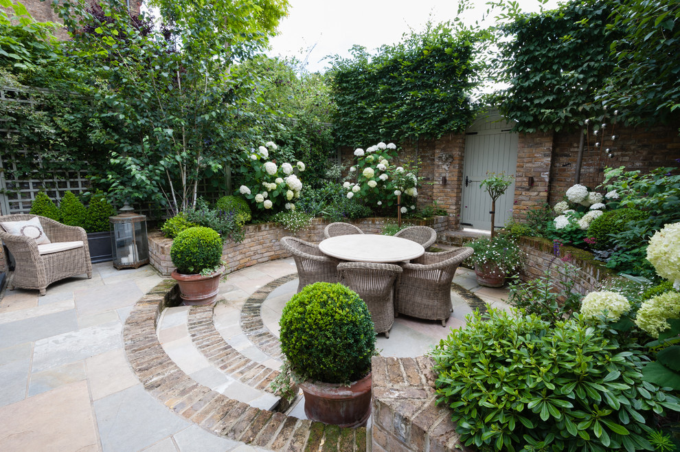 This is an example of a small traditional partial sun courtyard brick outdoor sport court in London for spring.