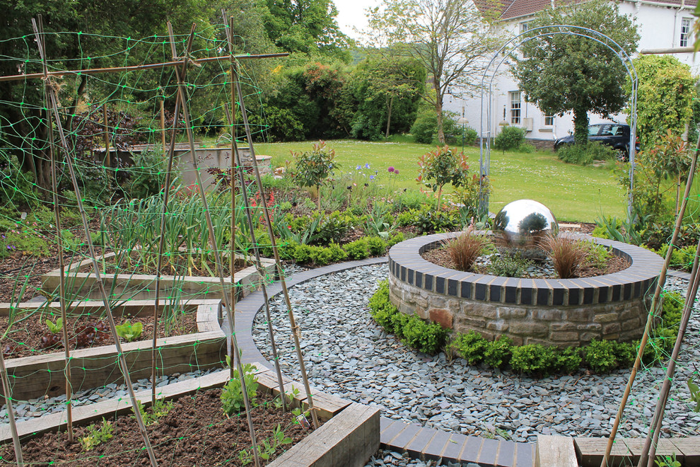 Foto de jardín tradicional de tamaño medio en patio trasero con estanque y adoquines de piedra natural