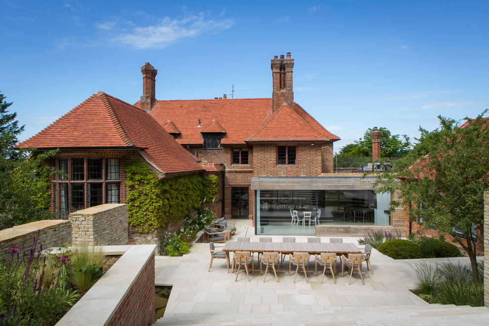 Photo of a large traditional back garden in Oxfordshire with natural stone paving.