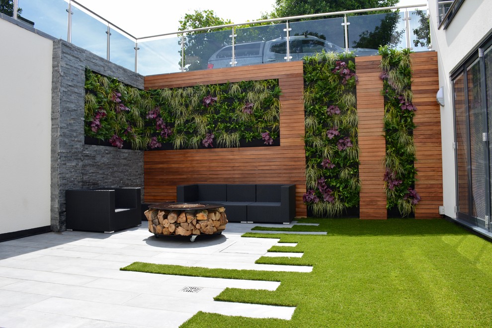 Design ideas for a medium sized contemporary courtyard full sun garden in London with a living wall.