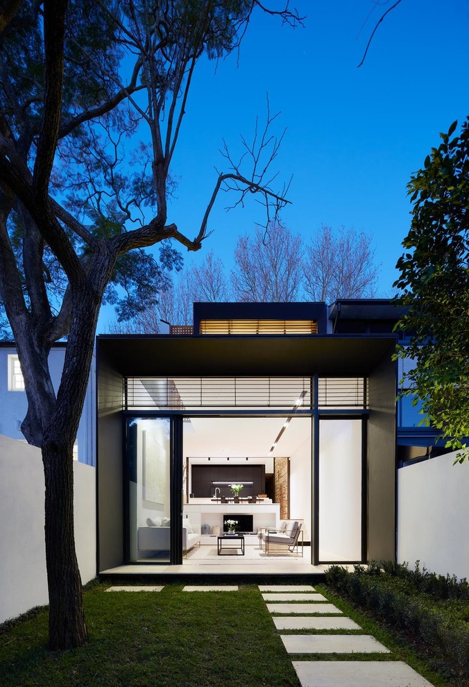 This is an example of a small contemporary back garden in Sydney with concrete paving.
