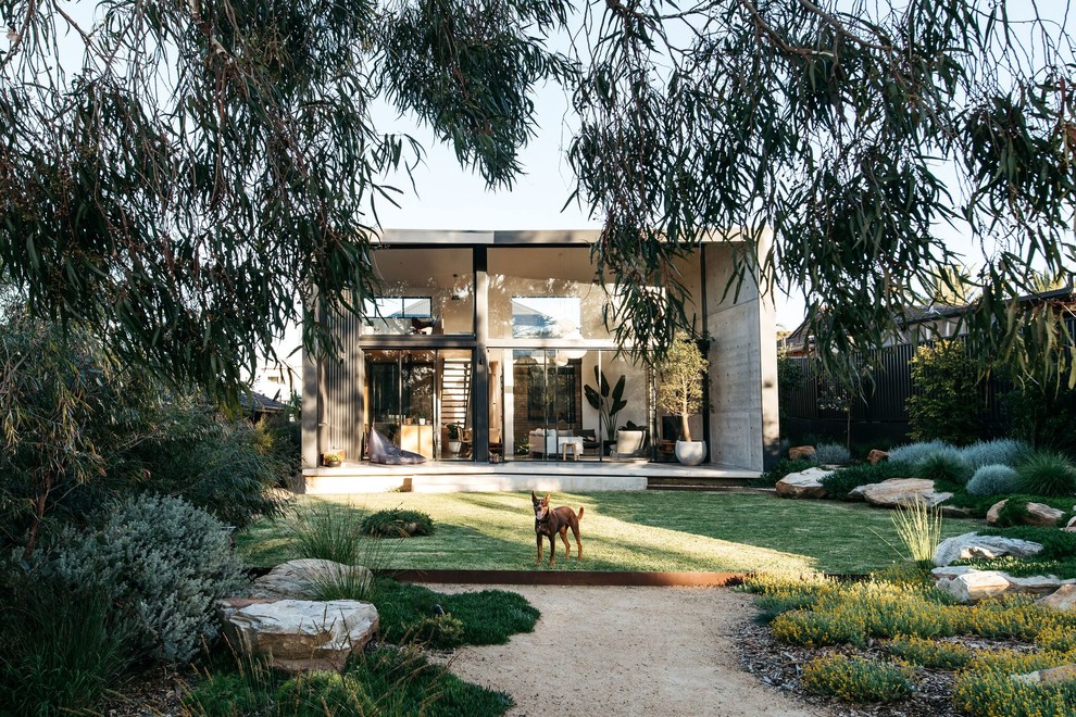 This is an example of a large rustic drought-tolerant backyard landscaping in Sydney.