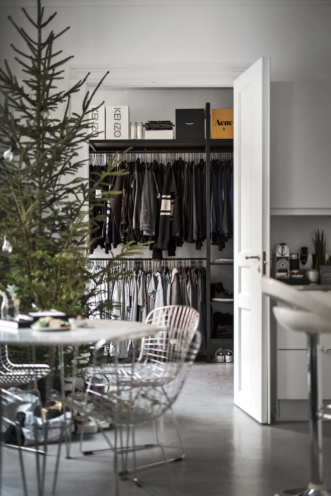 Scandi walk-in wardrobe for men in Stockholm with open cabinets.