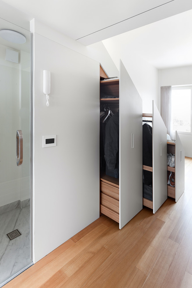 Idee per un piccolo armadio o armadio a muro contemporaneo con ante lisce, ante bianche e pavimento in legno massello medio