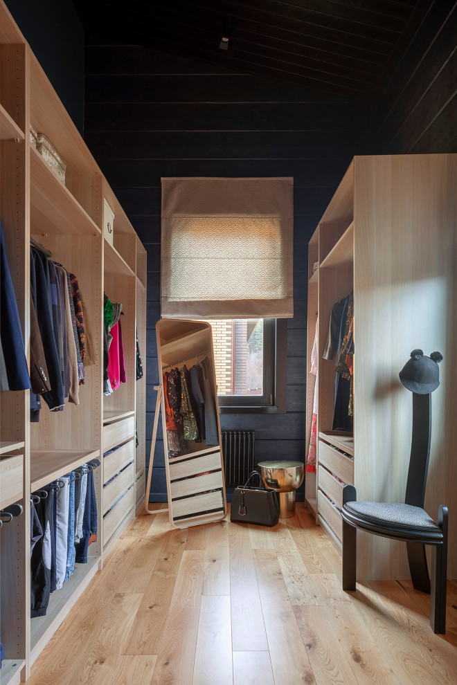 Design ideas for a contemporary gender neutral walk-in wardrobe in Moscow with open cabinets and brown floors.
