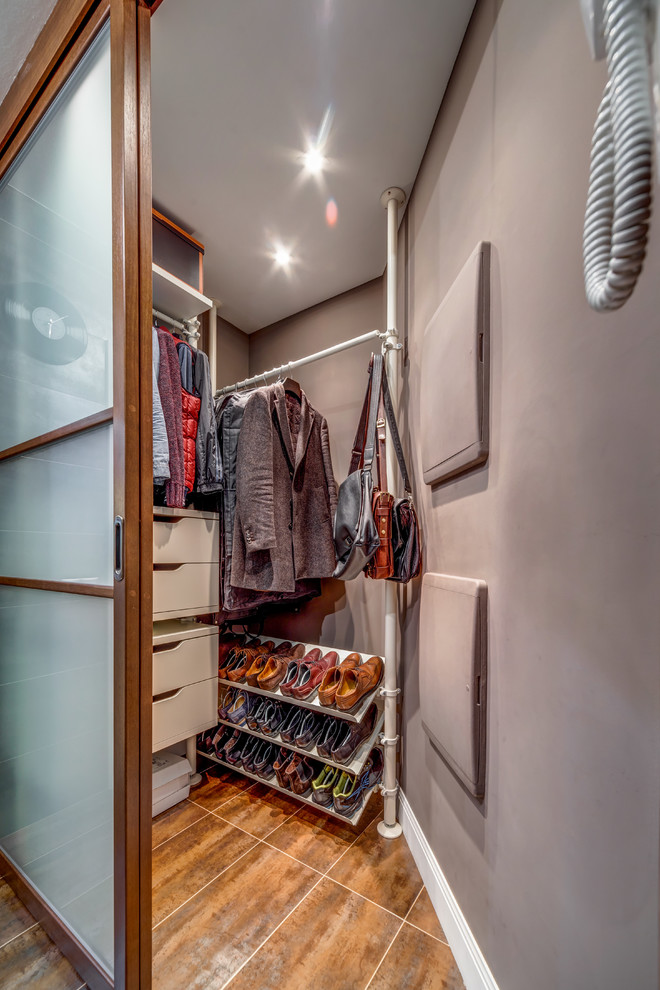 Modern inredning av ett walk-in-closet, med brunt golv