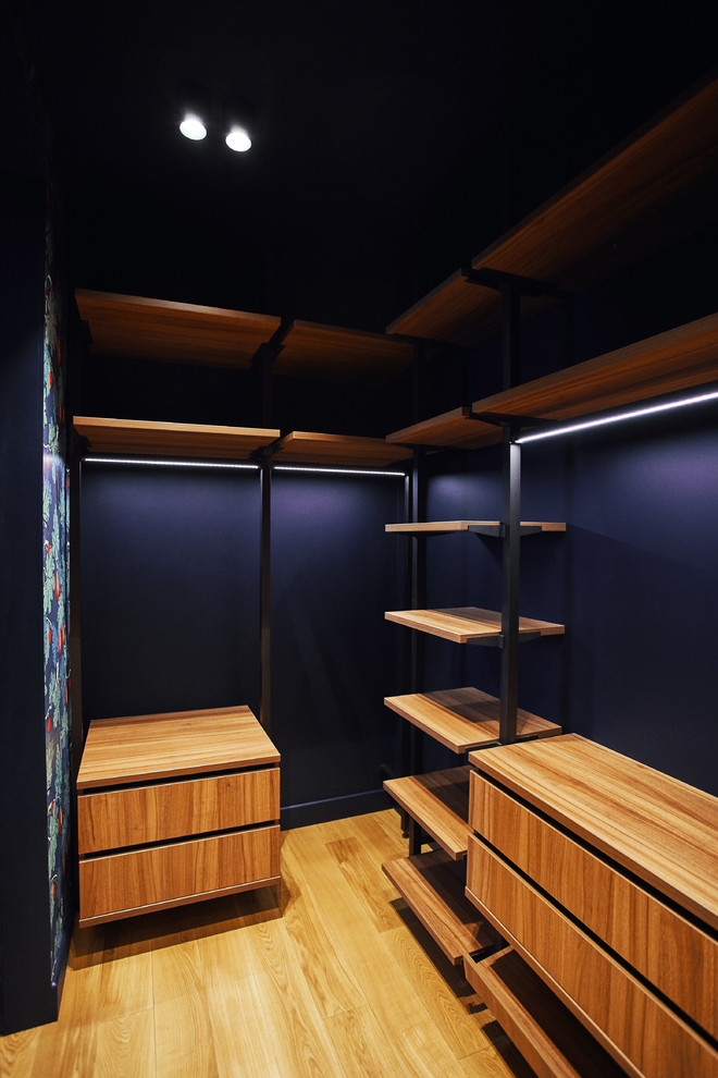 Foto på ett litet funkis walk-in-closet för könsneutrala, med mellanmörkt trägolv