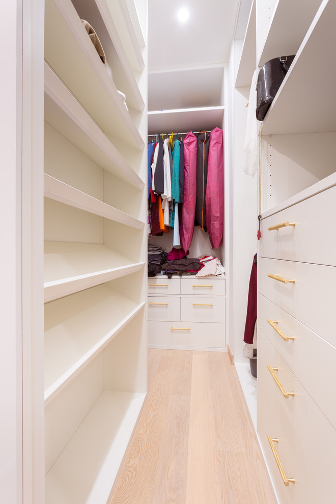 Walk-in closet - mid-sized contemporary medium tone wood floor and white floor walk-in closet idea in Moscow with flat-panel cabinets and white cabinets