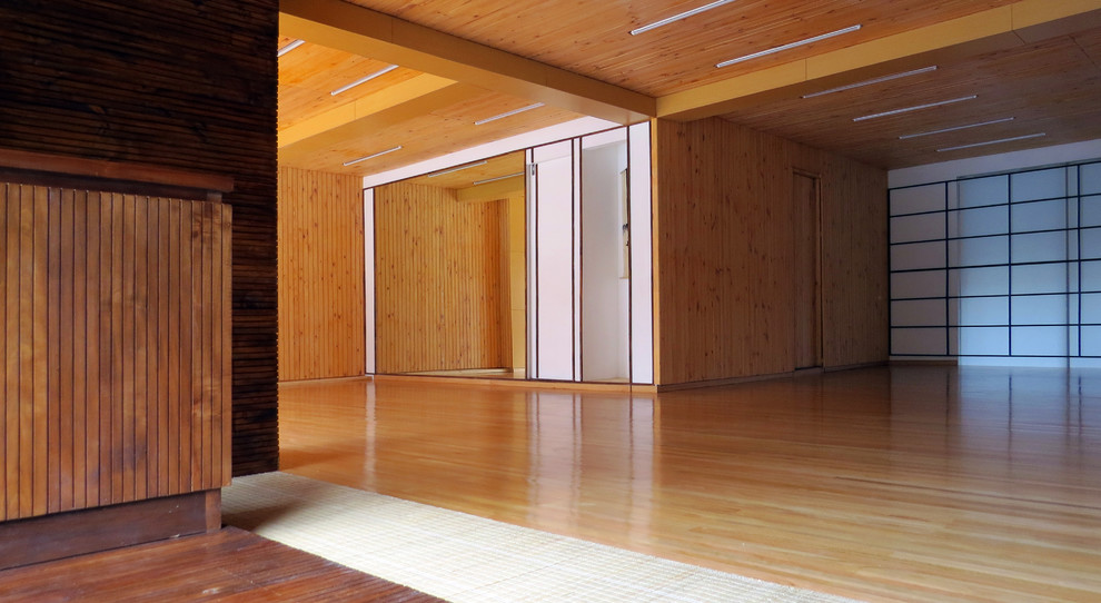 Immagine di una palestra multiuso tropicale con pavimento in legno massello medio