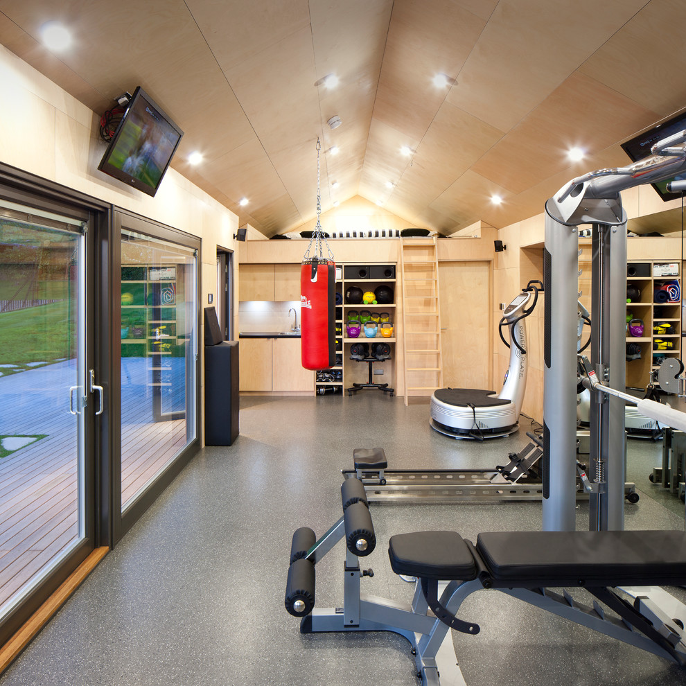 This is an example of a large contemporary multi-use home gym in Barcelona with ceramic flooring, beige walls and feature lighting.