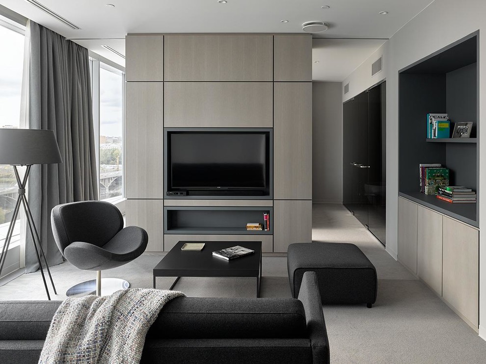 Idée de décoration pour un salon design avec un mur gris, moquette, un sol gris et éclairage.