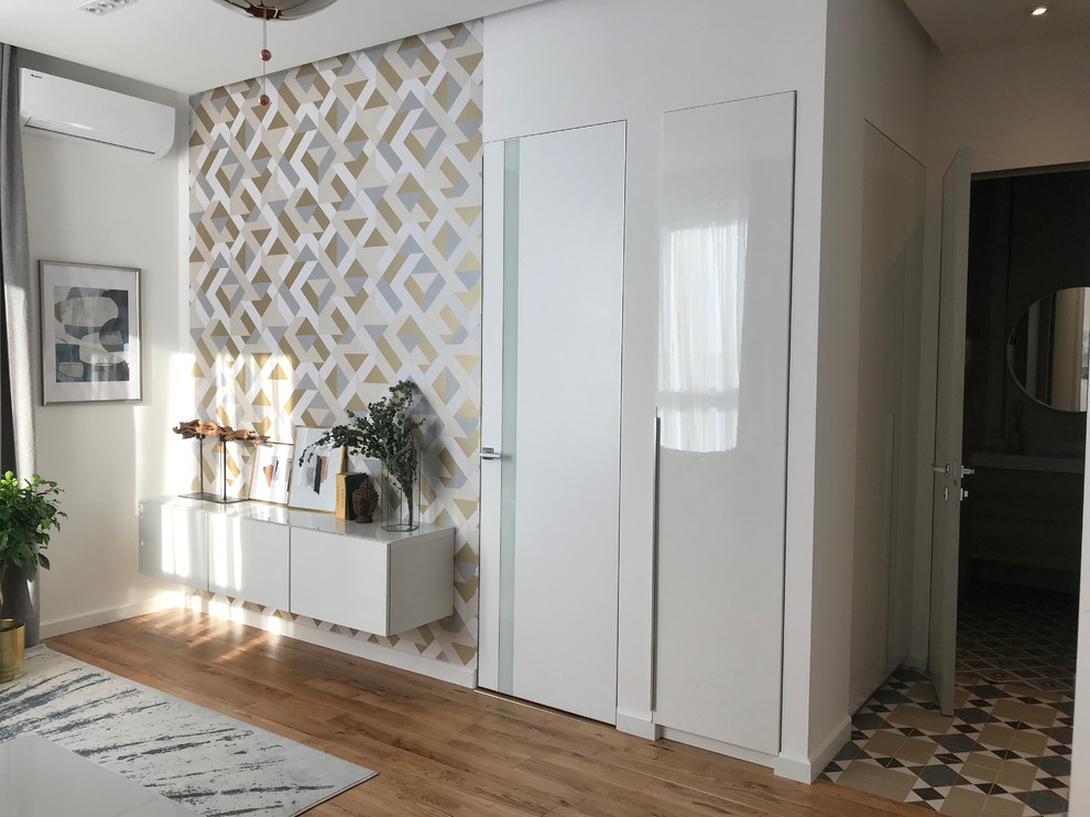 Ejemplo de salón abierto contemporáneo pequeño sin televisor con paredes blancas, suelo de madera en tonos medios y suelo multicolor