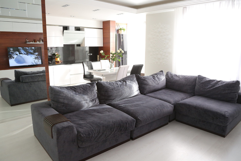 Стильный дизайн: гостиная комната среднего размера в современном стиле с белыми стенами и полом из ламината - последний тренд