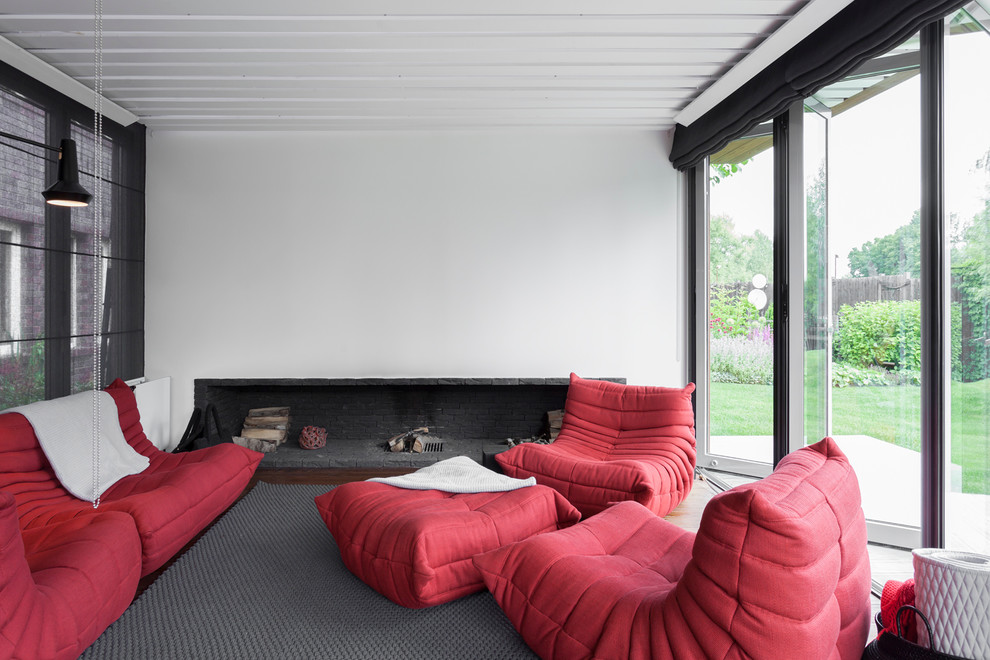 Photo of a contemporary formal living room in Moscow with white walls, carpet, a standard fireplace and a stone fireplace surround.