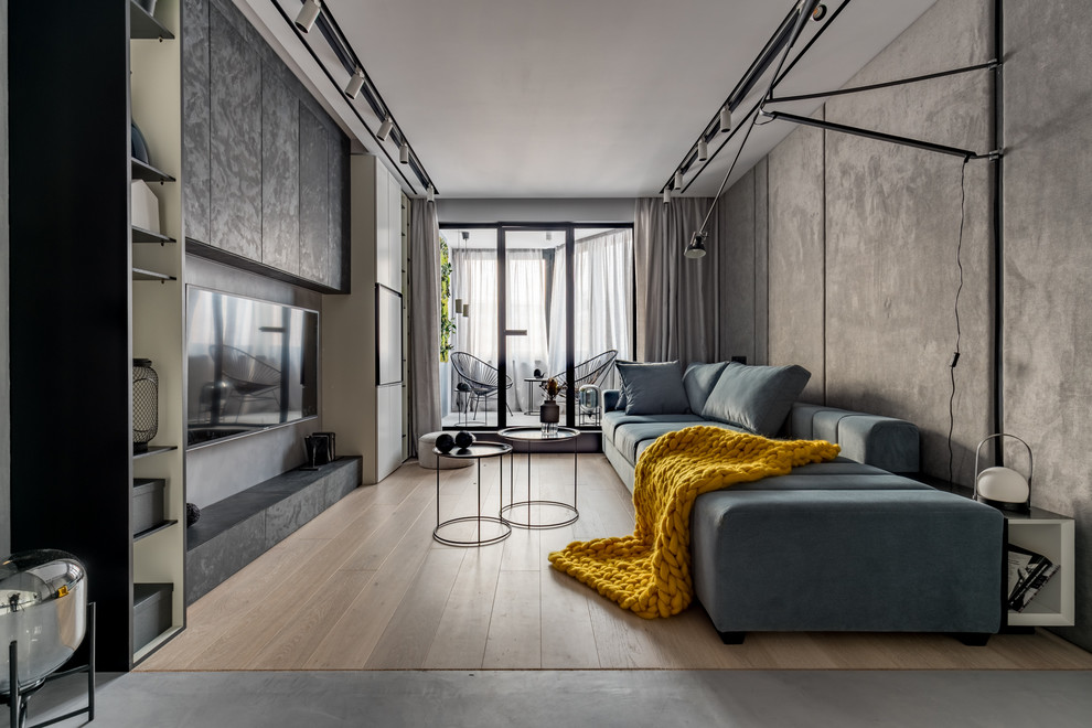 Пример оригинального дизайна: маленькая гостиная комната в современном стиле с серыми стенами, светлым паркетным полом, бежевым полом и телевизором на стене для на участке и в саду