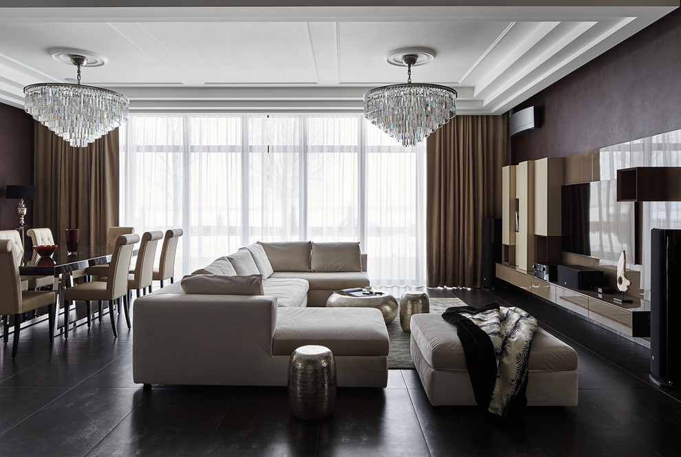 На фото: открытая гостиная комната среднего размера в современном стиле с коричневыми стенами, полом из керамогранита, телевизором на стене, серым полом и тюлем на окнах