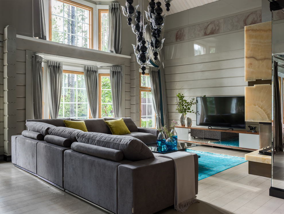Idée de décoration pour un salon design de taille moyenne avec un mur gris, parquet clair et un sol gris.