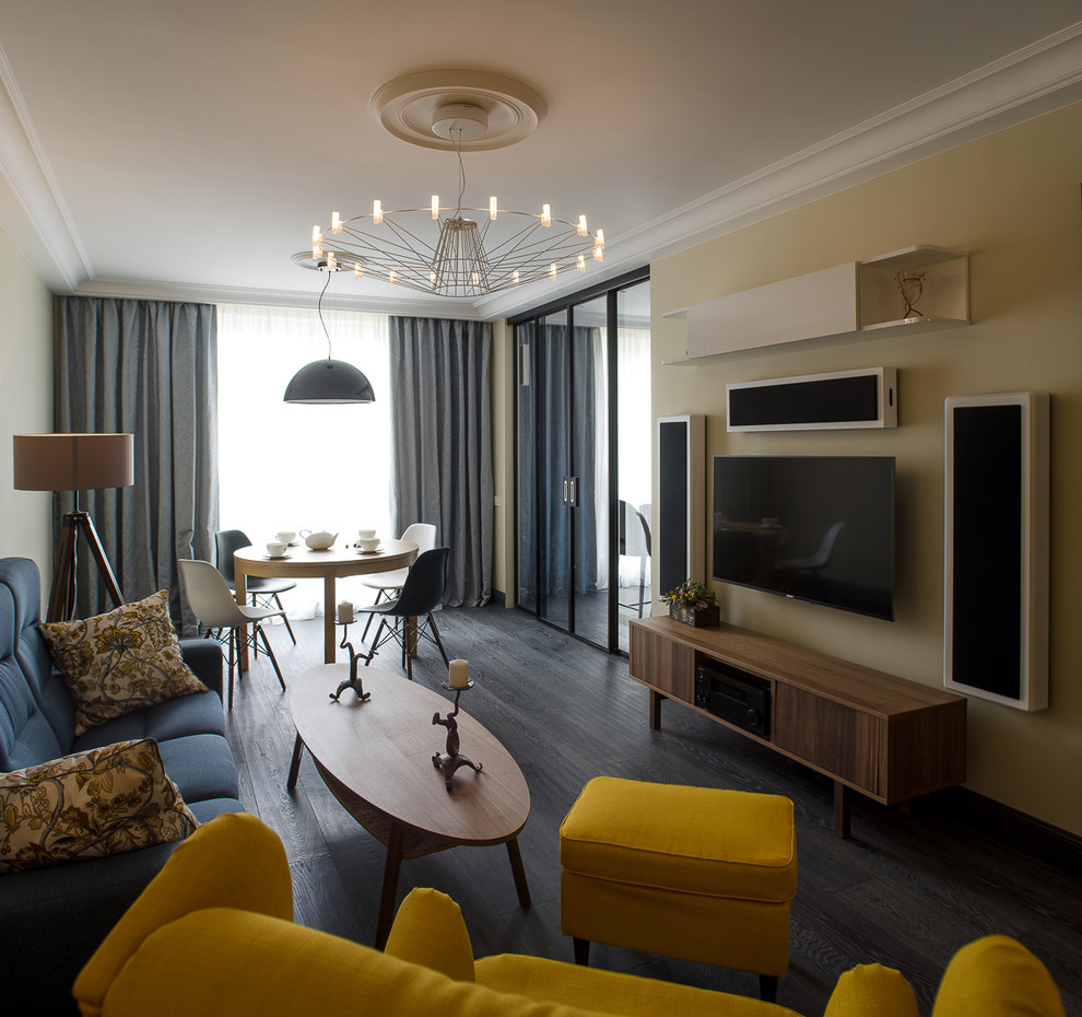 Свежая идея для дизайна: гостиная комната в скандинавском стиле с бежевыми стенами, темным паркетным полом, черным полом и телевизором на стене - отличное фото интерьера