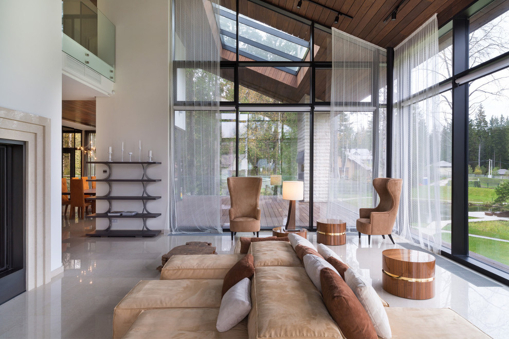 Идея дизайна: гостиная комната в современном стиле с белыми стенами и двусторонним камином