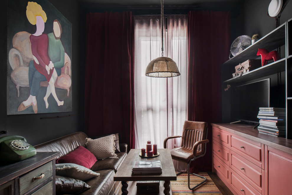 На фото: открытая, объединенная гостиная комната среднего размера в стиле лофт с черными стенами и полом из ламината