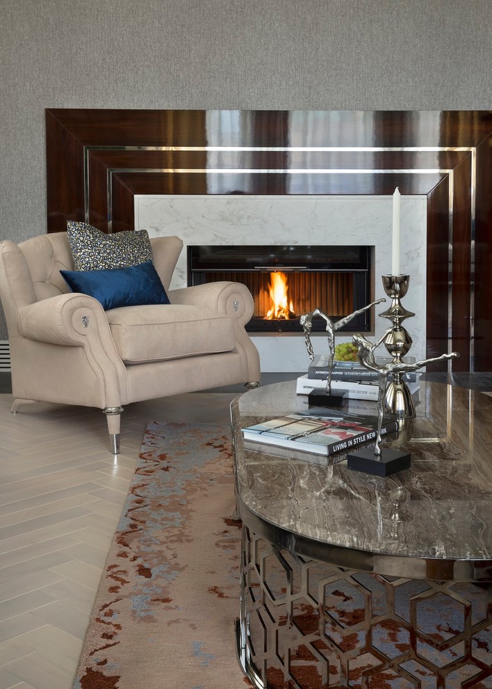 Example of a trendy formal light wood floor living room design in Moscow with gray walls, a standard fireplace and a stone fireplace