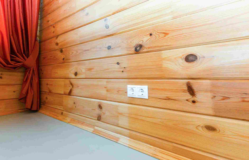 Immagine di un soggiorno tradizionale di medie dimensioni e stile loft con pareti beige, pavimento in legno verniciato, nessun camino, TV a parete e pavimento grigio