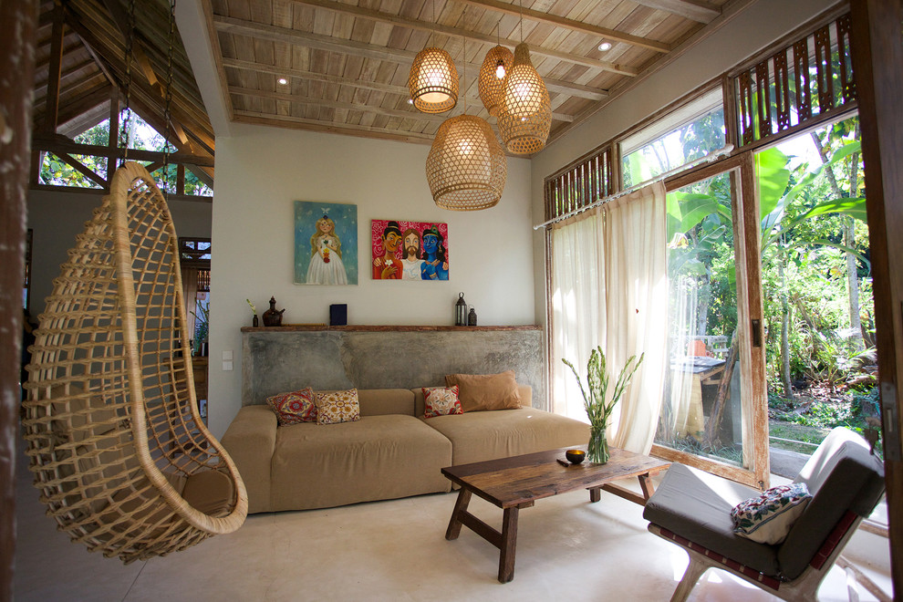 This is an example of a world-inspired open plan living room in Other with white walls.